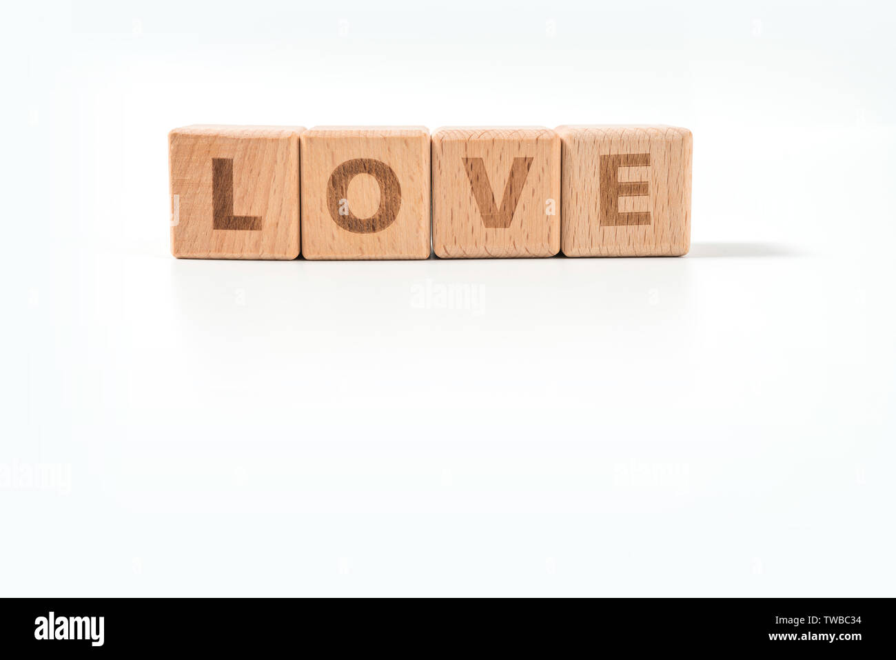 word LOVE on wood cube dices on white background. Stock Photo