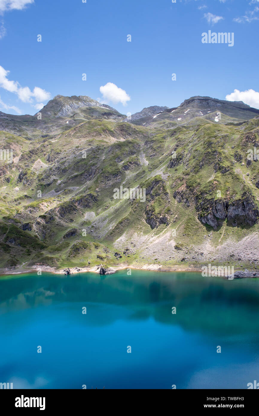 Mountain landscape near the Saliencia glacial lakes. Calabazosa lake in the Somiedo national park, Spain, Asturias. Turquoise crystal clear water. Whi Stock Photo