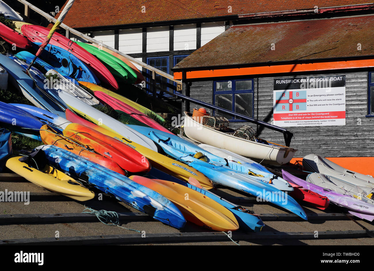 Canoes and boats on the slipway at Runswick Bay, North Yorkshire, UK