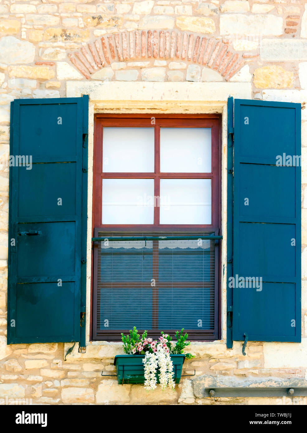 Beautiful vintage window with open blue shutters Stock Photo