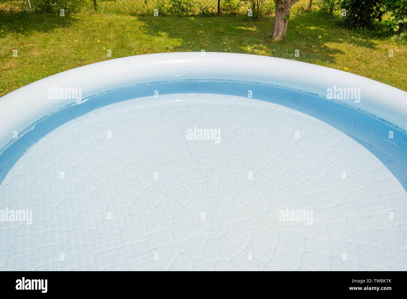 A round, blue, garden pool for children Stock Photo - Alamy