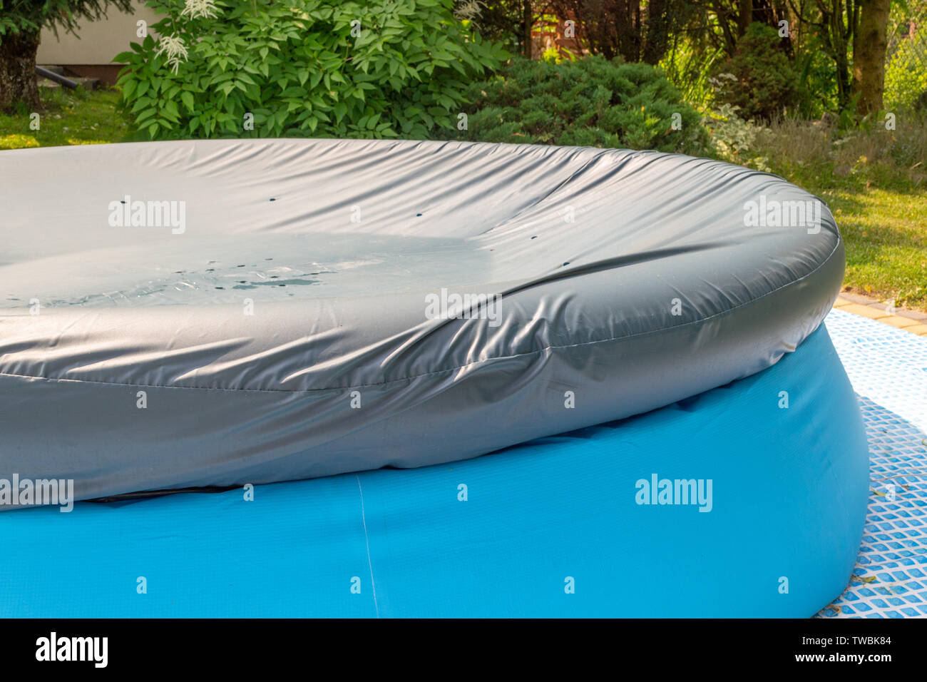A round, blue, garden pool for children Stock Photo - Alamy