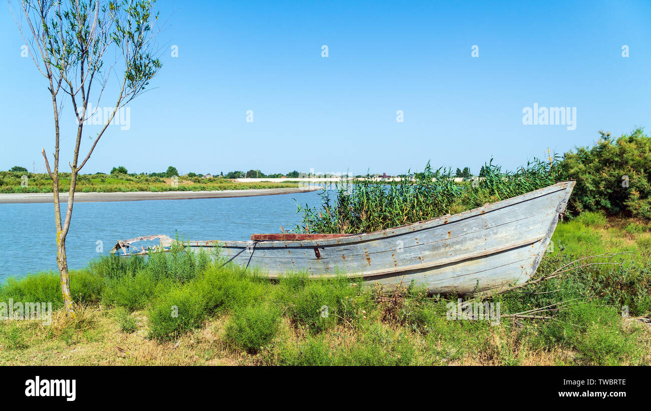 Fishing boat by the river bank Stock Photo - Alamy