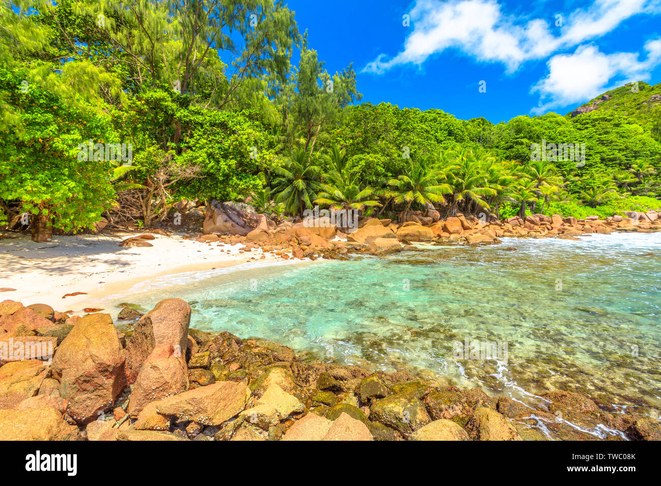 La Digue, Seychelles islands. Remote Anse Caiman with pristine beach between Anse Fourmis and Anse Cocos protected by huge rock formations.Anse Caiman Stock Photo