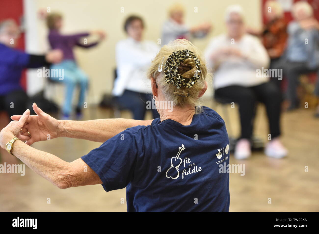 Exercise class for the elderly at a day centre UK Stock Photo