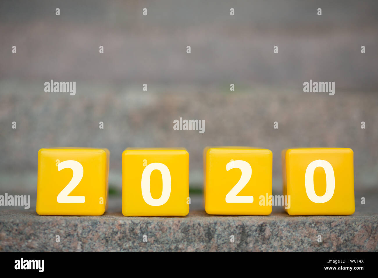 Go further. Yellow 2020 cubes standing on the first stair of the long future path, panorama, copy space Stock Photo