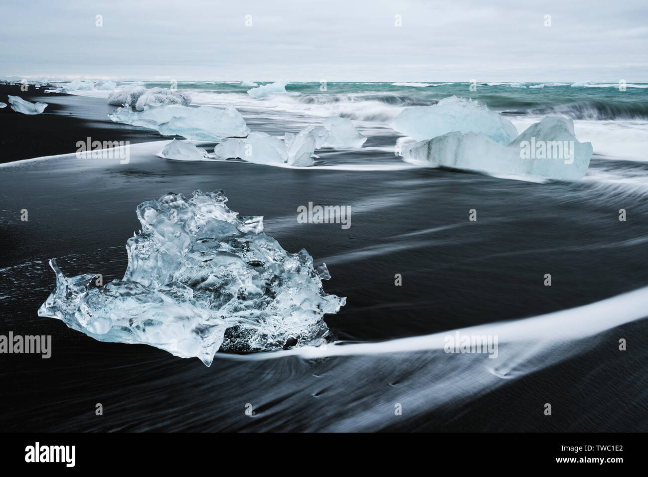 Icy beach in Iceland, Europe. Ice on the black volcanic sand on the Atlantic Ocean. Tourist attraction. Amazing landscape cloudy day Stock Photo