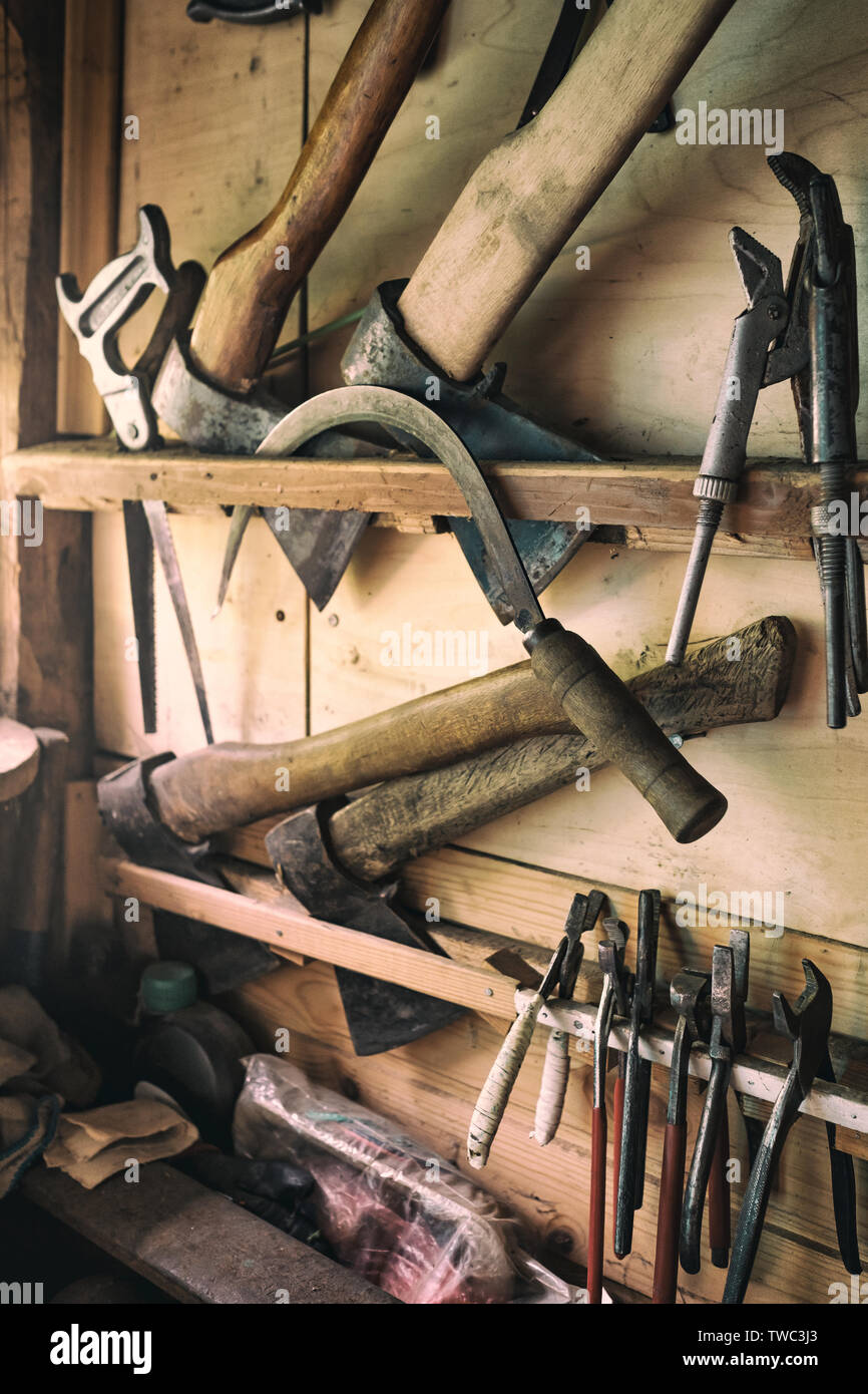 Old tools for carpentry work, hanging on rack Stock Photo