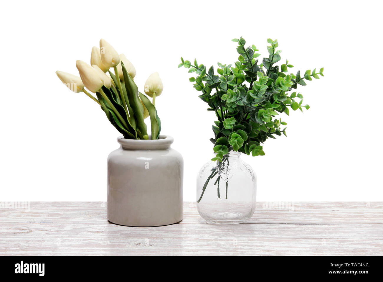 Plants in Vases on Wooden Background Stock Photo