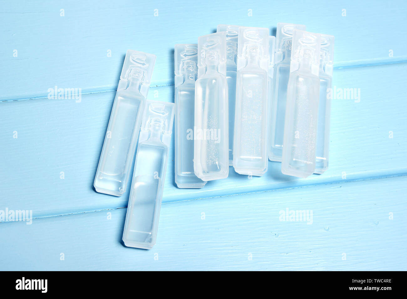 Vials of Saline Solution on Wooden Background Stock Photo