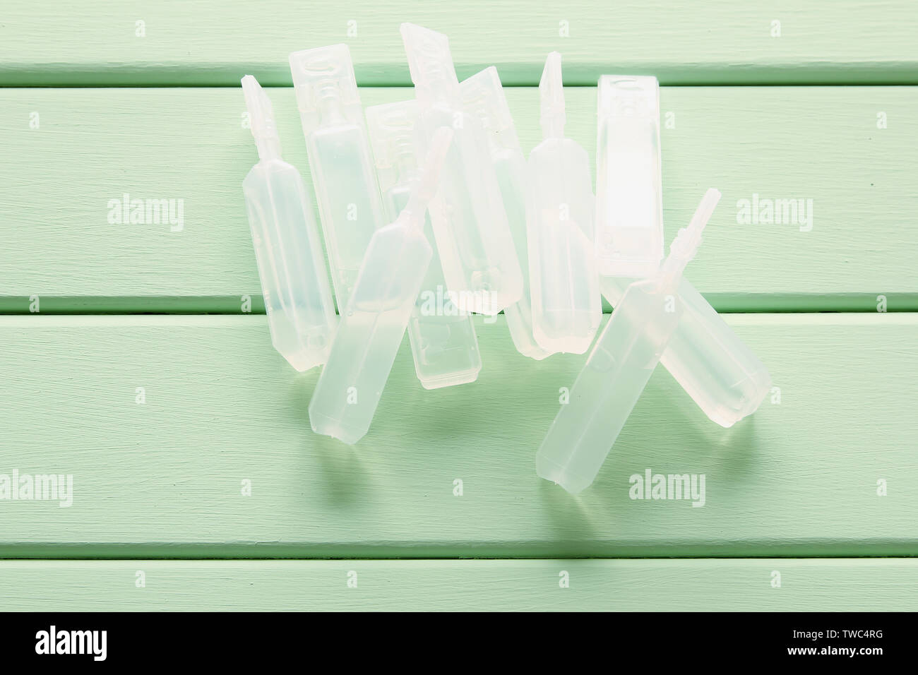 Vials of Saline Solution on Wooden Background Stock Photo