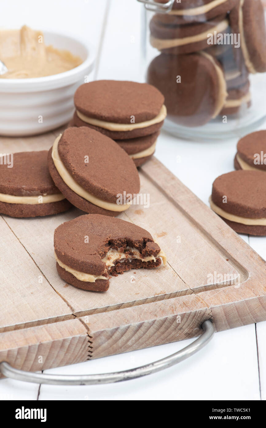 Homemade Chocolate peanut butter shortbread bicuits. Round chocolate shortbread biscuits with peanut butter cream in the middle Stock Photo