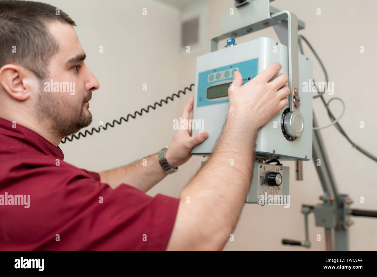 The doctor radiologist sets up an old veterinary Xray machine before