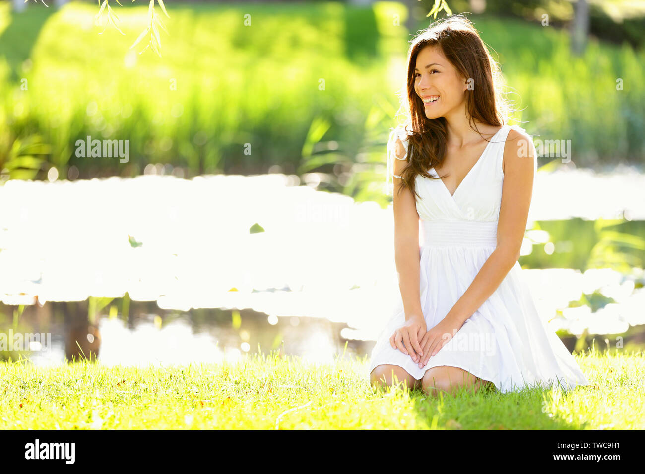 Asian woman sitting in park in spring or summer. Beautiful young woman ...