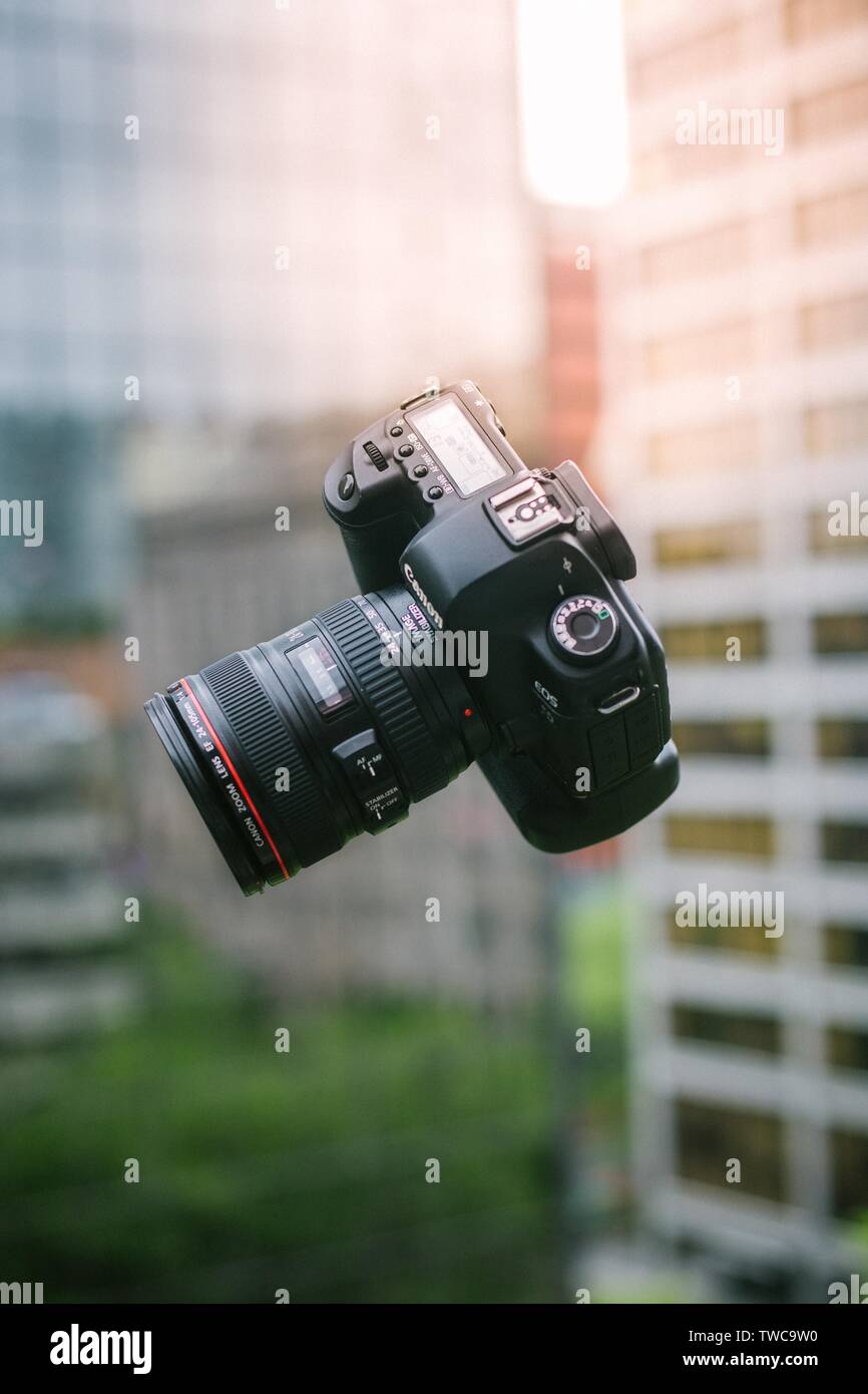 falling professional camera captured in the air with blurred architecture  in the background Stock Photo - Alamy