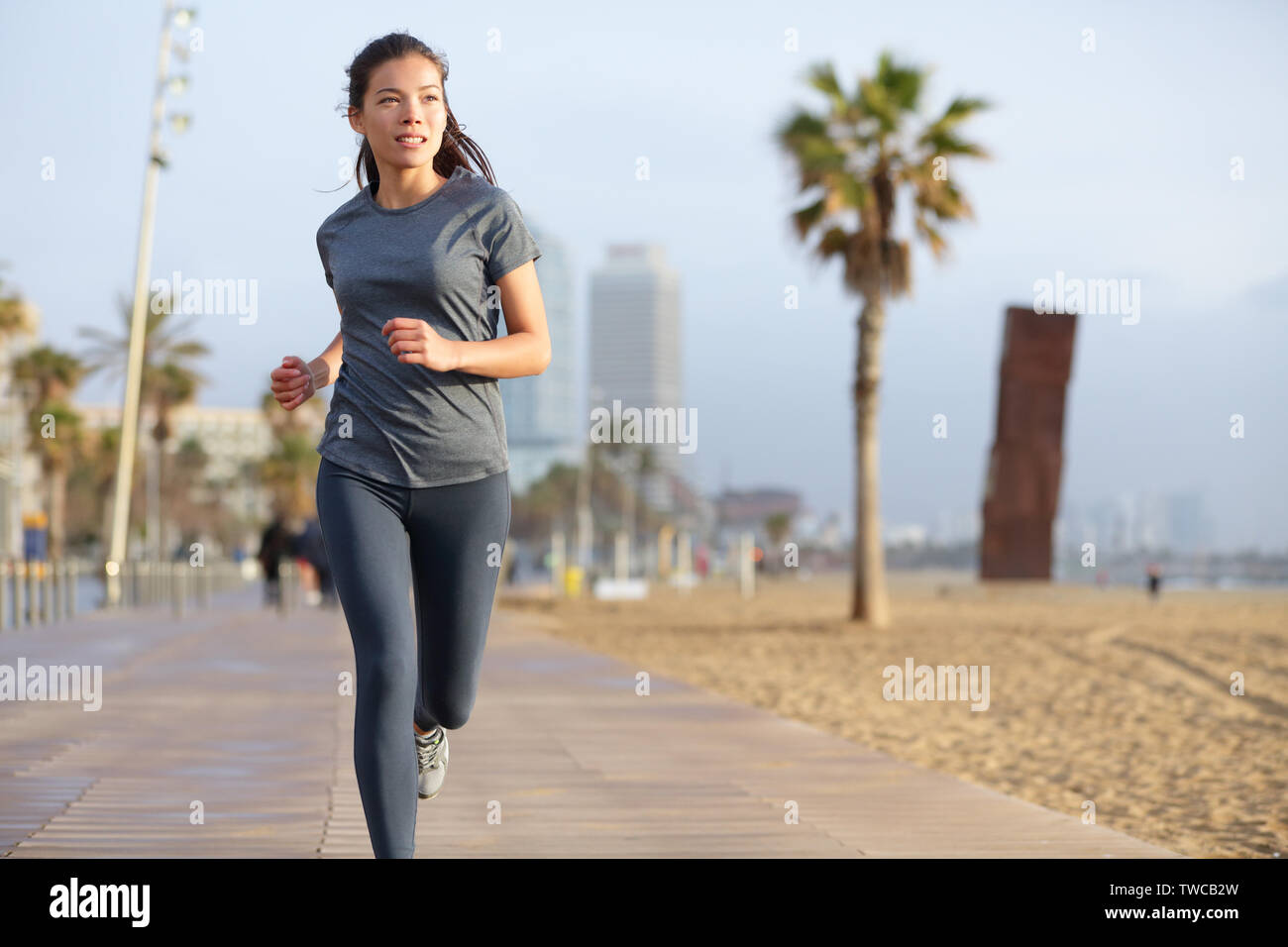 Running woman jogging on Barcelona Beach, Barceloneta. Healthy lifestyle girl  runner training outside on boardwalk. Mixed race Asian Caucasian fitness  woman working out outdoors in Catalonia, Spain Stock Photo - Alamy