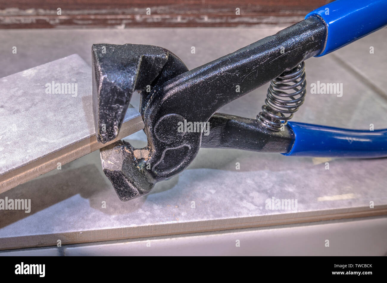 Closeup of a pair of nibblers / nippers cutting a small piece off a