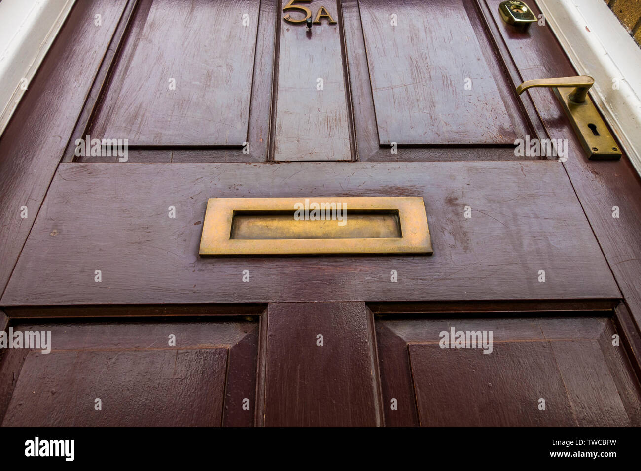 POV shot from ground level of a typical UK front door, somewhat tired