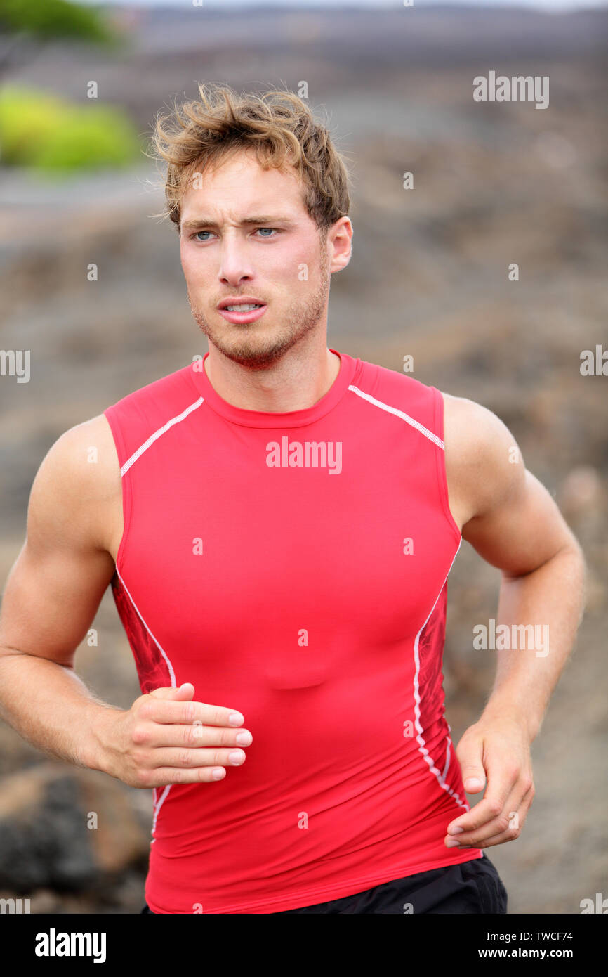 Running man male runner closeup. Sport athlete jogging training