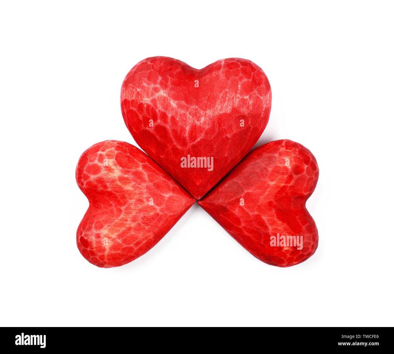 Close up three red painted natural wooden carved hearts isolated on white background Stock Photo