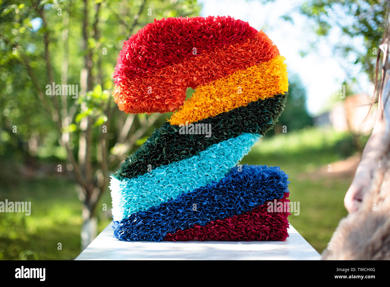 designer figure two in the garden made of artificial flowers buds Stock