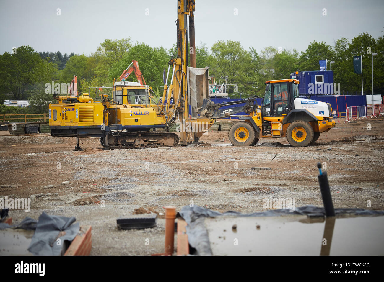 Pile driver rig at work on a building site for new homes in Cheshire forcing stone into the foundations Stock Photo