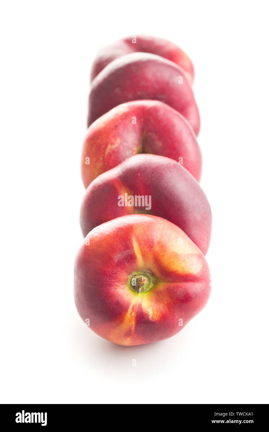 Ripe flat nectarines isolated on white background. Stock Photo