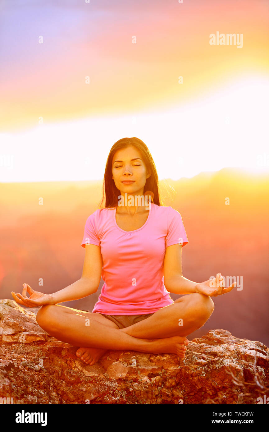 Meditating yoga woman at sunset in Grand Canyon. Female model ...