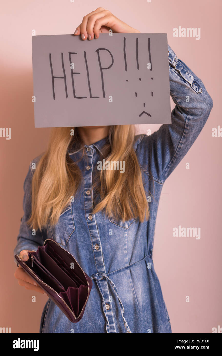 Woman holding empty wallet and paper with word help while standing in ...