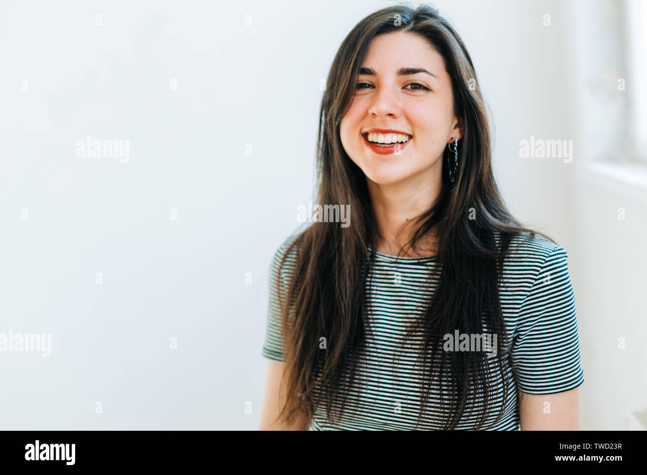 young confident brunette woman smiling Stock Photo