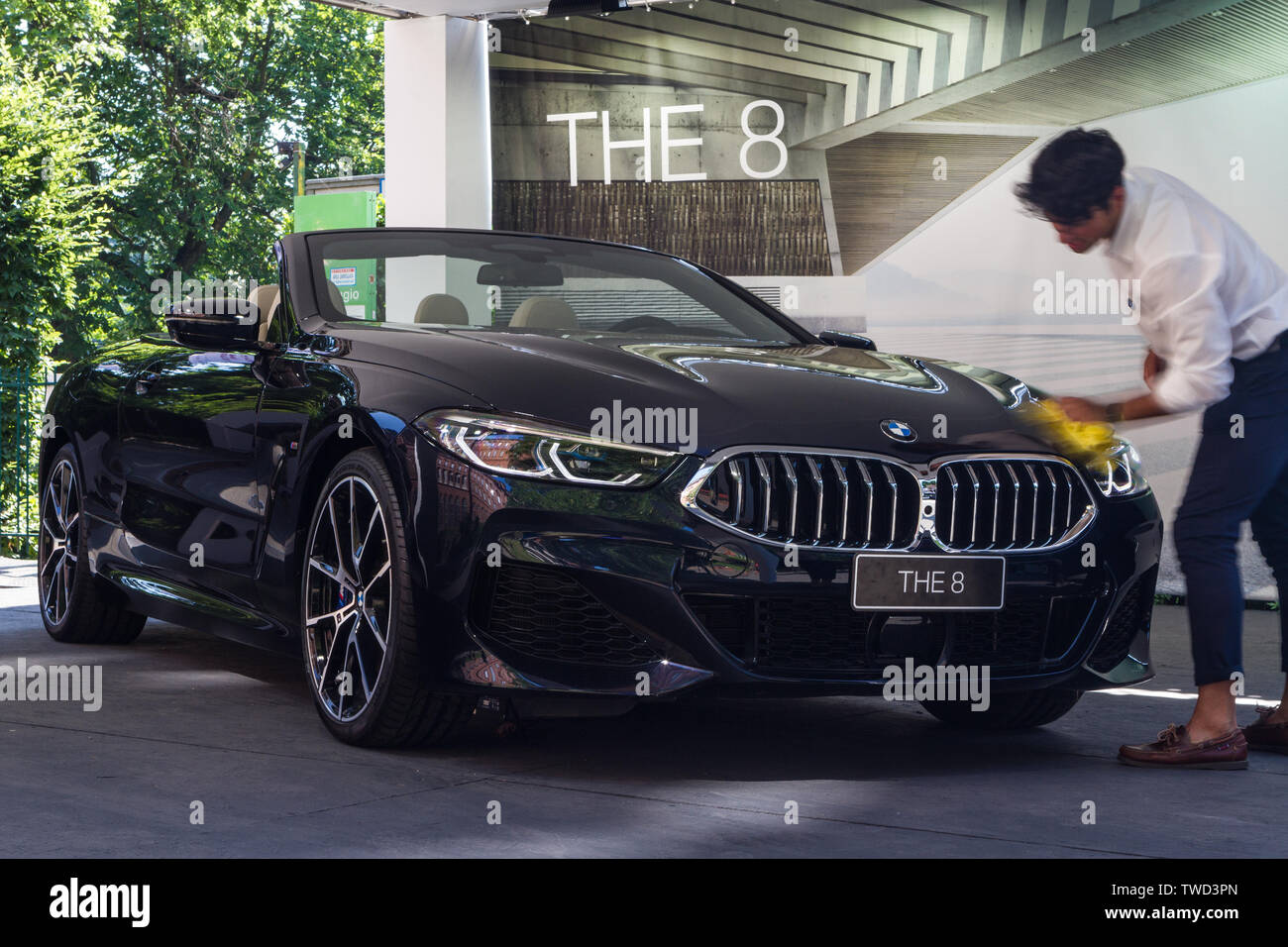 A man dusting a BMW M850i Cabrio (BMW 8 series). 2019 edition of Parco Valentino car show hosts cars by many brands and car designers in Valentino Park in Torino, Italy. Stock Photo