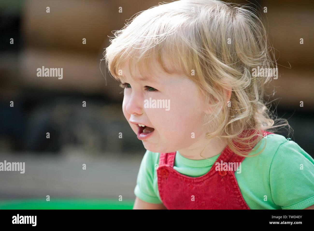 crying little blonde caucasian child face closeup view Stock Photo