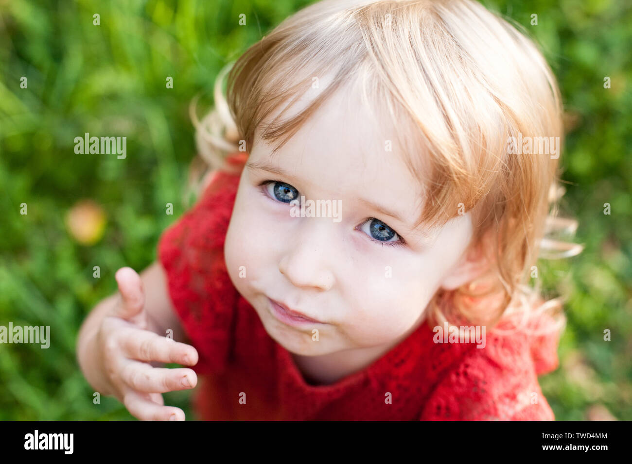 funny kid girl emational face closeup top view Stock Photo