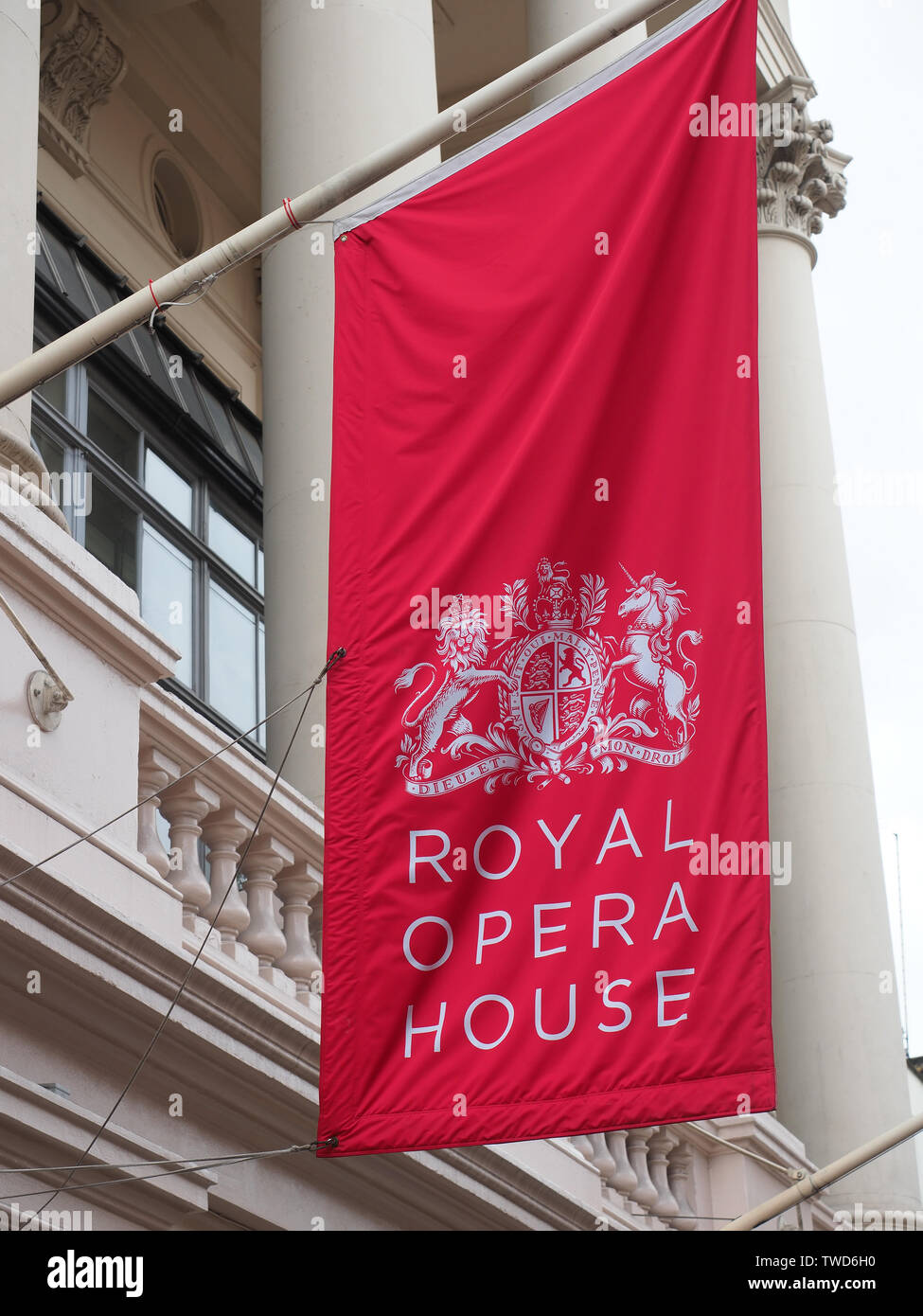 Red flag hanging still outside the Royal Opera House in Covent Garden London Stock Photo