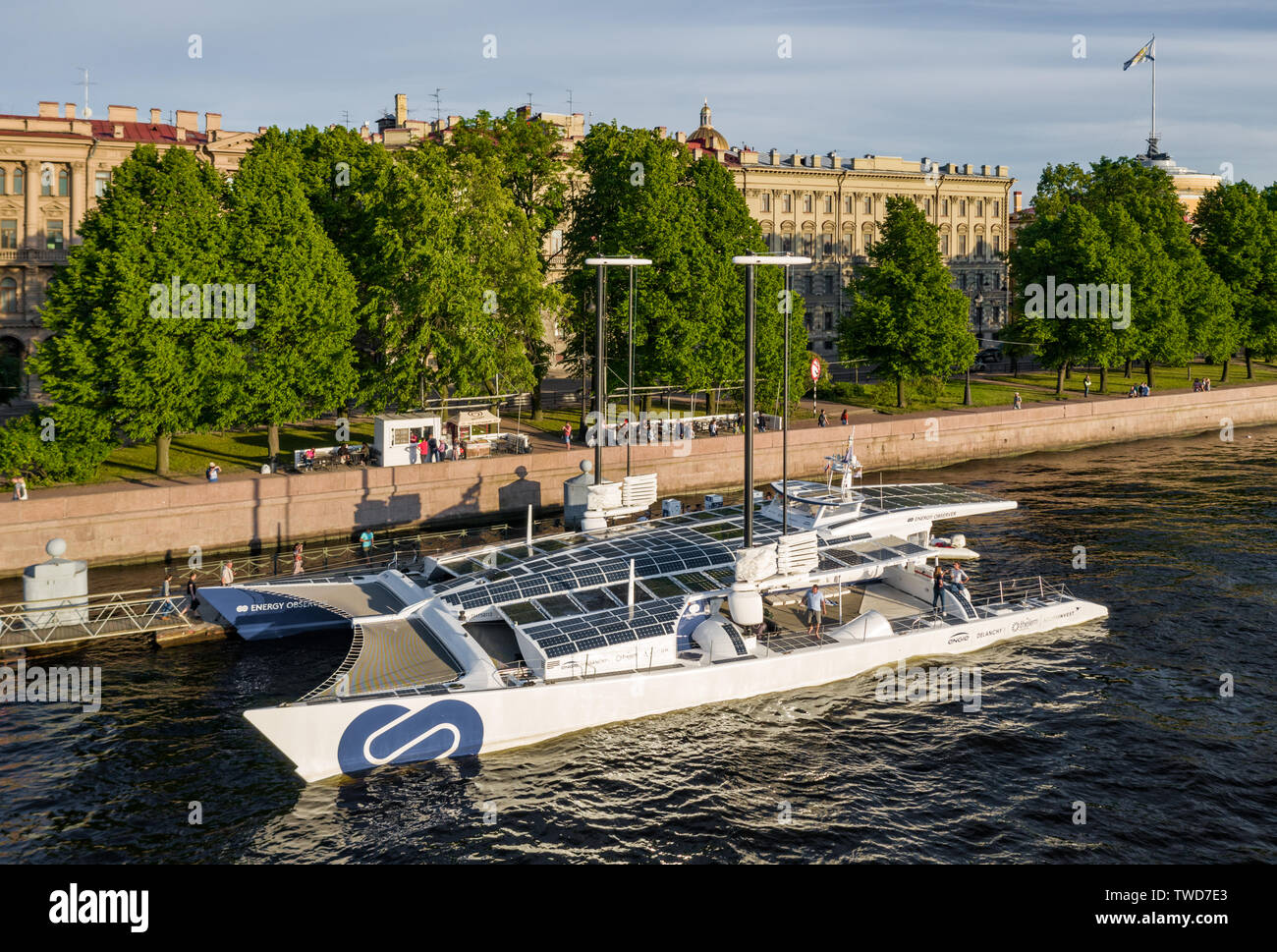 The French Catamaran Energy Observer against sights of the city, working for pure and renewables source of energy, solar energy, wind power, Admiralty Stock Photo