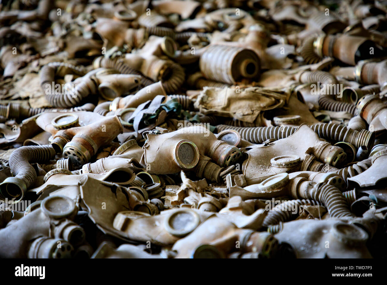 Eastern Europe, Ukraine, Pripyat, Chernobyl. Gas masks, many of them child-sized, litter the floor of an abandoned school. Stock Photo