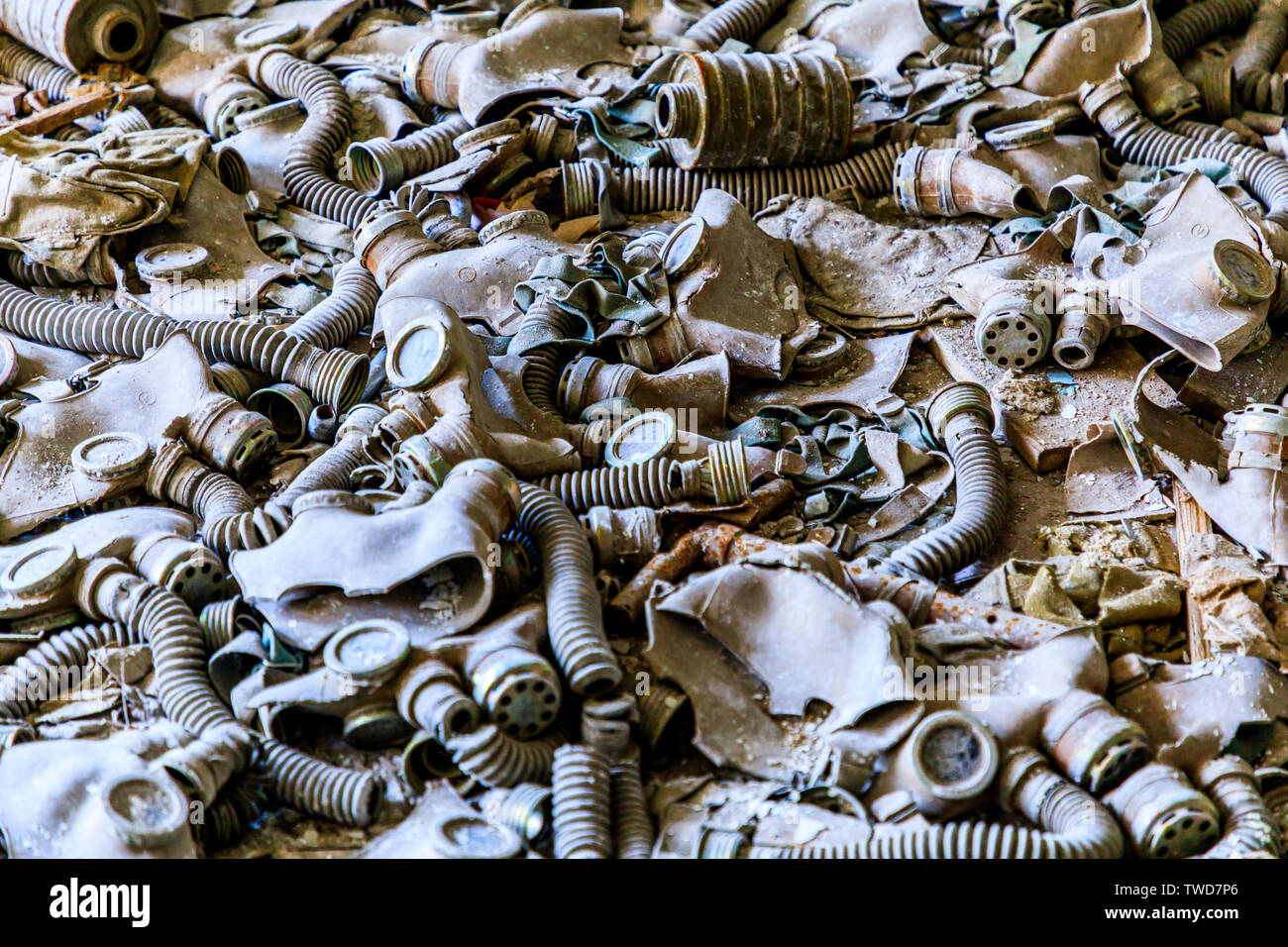 Eastern Europe, Ukraine, Pripyat, Chernobyl. Gas masks, many of them child-sized, litter the floor of an abandoned school. Stock Photo