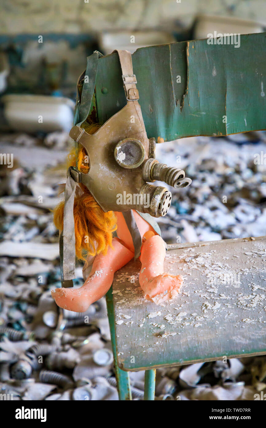 Eastern Europe, Ukraine, Pripyat, Chernobyl. Gas masks, many of them child-sized, litter the floor of an abandoned school. One has been placed over a Stock Photo