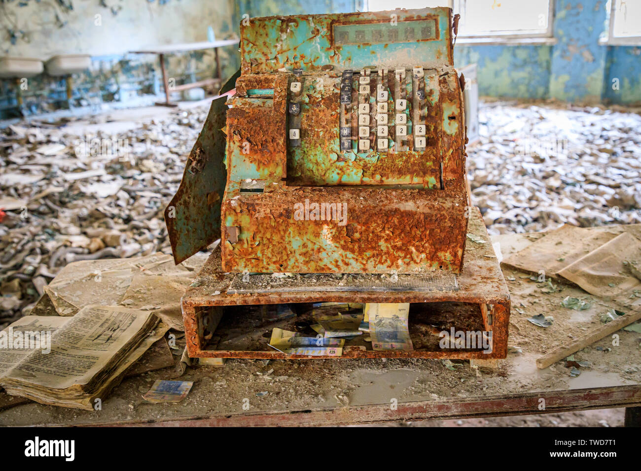 Eastern Europe, Ukraine, Pripyat, Chernobyl. Rusted cash register, book and money. April 11, 2018. Stock Photo