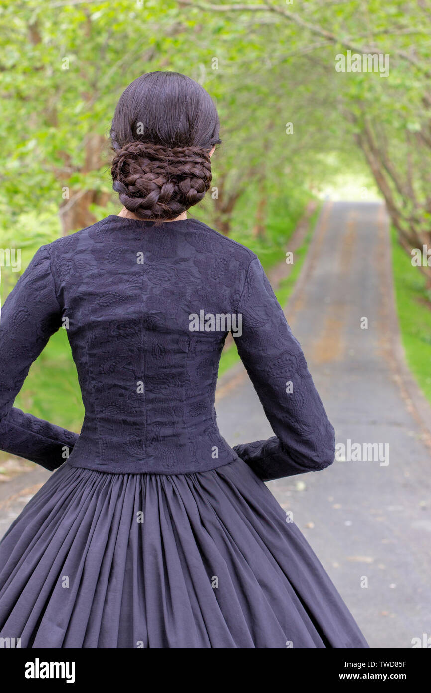 Dark-haired Victorian woman in black ensemble Stock Photo