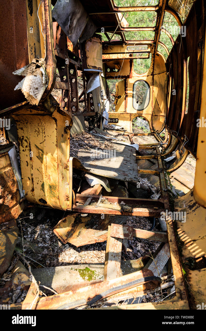 Eastern Europe, Ukraine, Pripyat, Chernobyl. Inside rusted overturned school bus. Stock Photo