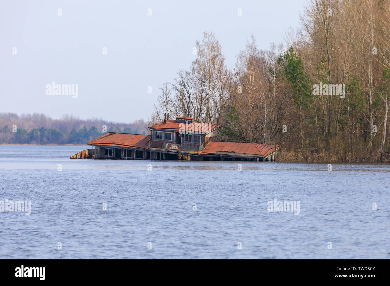 Eastern Europe, Ukraine, Pripyat, Chernobyl. Abandoned houseboat and restaurant in lake. Stock Photo