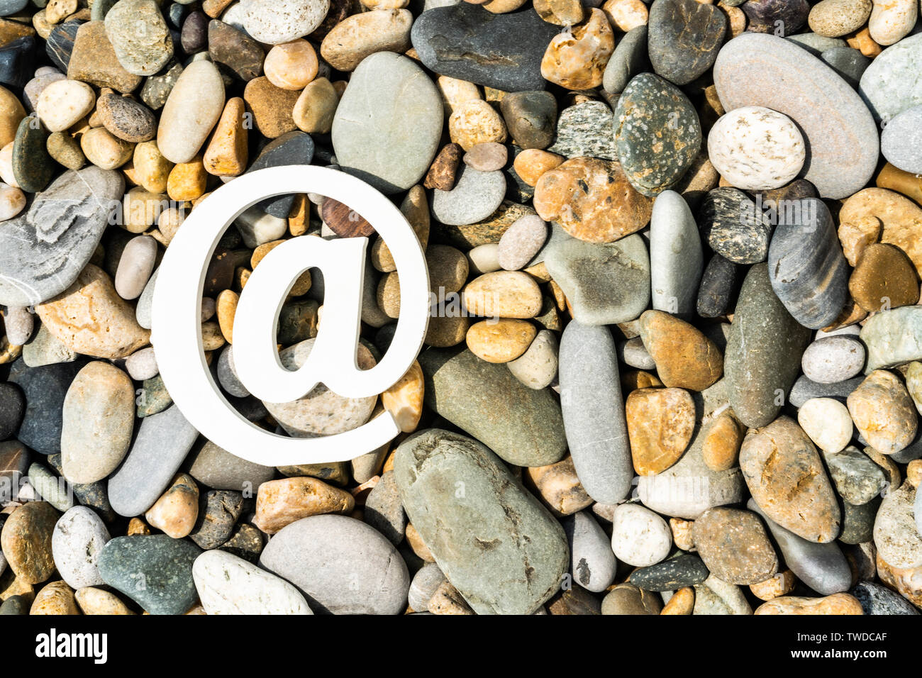 Email sign on the sea pebbles. Concept for email, communication or contact us Stock Photo