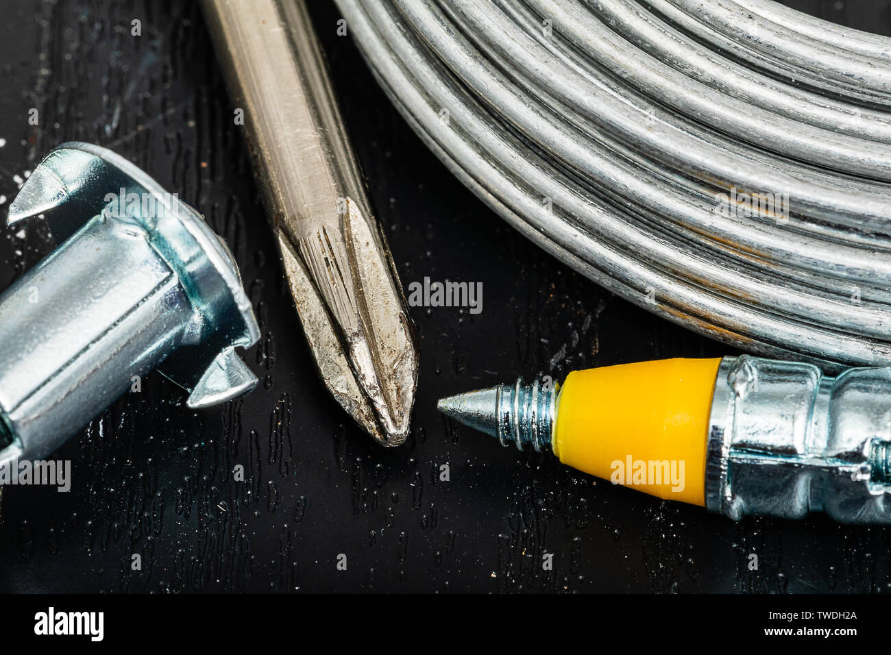 Screw Drivers, Wire and Anchor Screws. A group of tools and materials