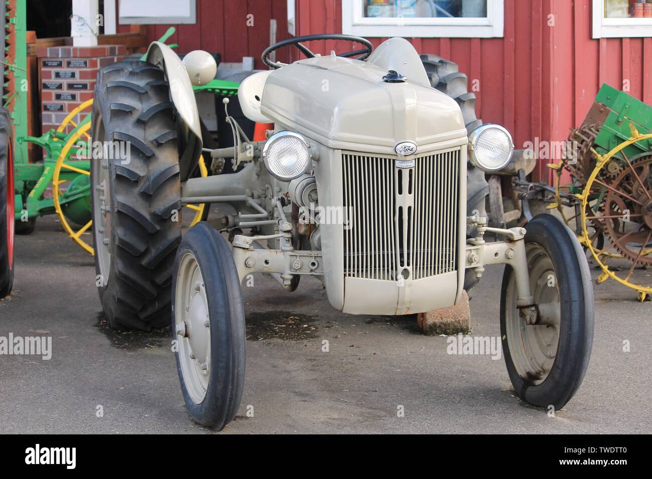 Restored classic antique Ford farm tractor displayed at a Pacific Northwest U.S. county fair with other vintage farm machinery on Aug. 30, 2015. Stock Photo