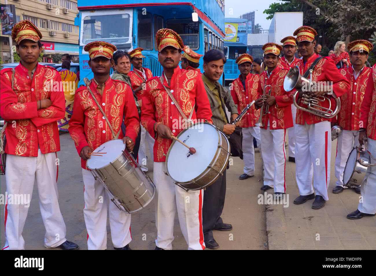 Uniformed members of a marching band in Mumbai, India, waiting to