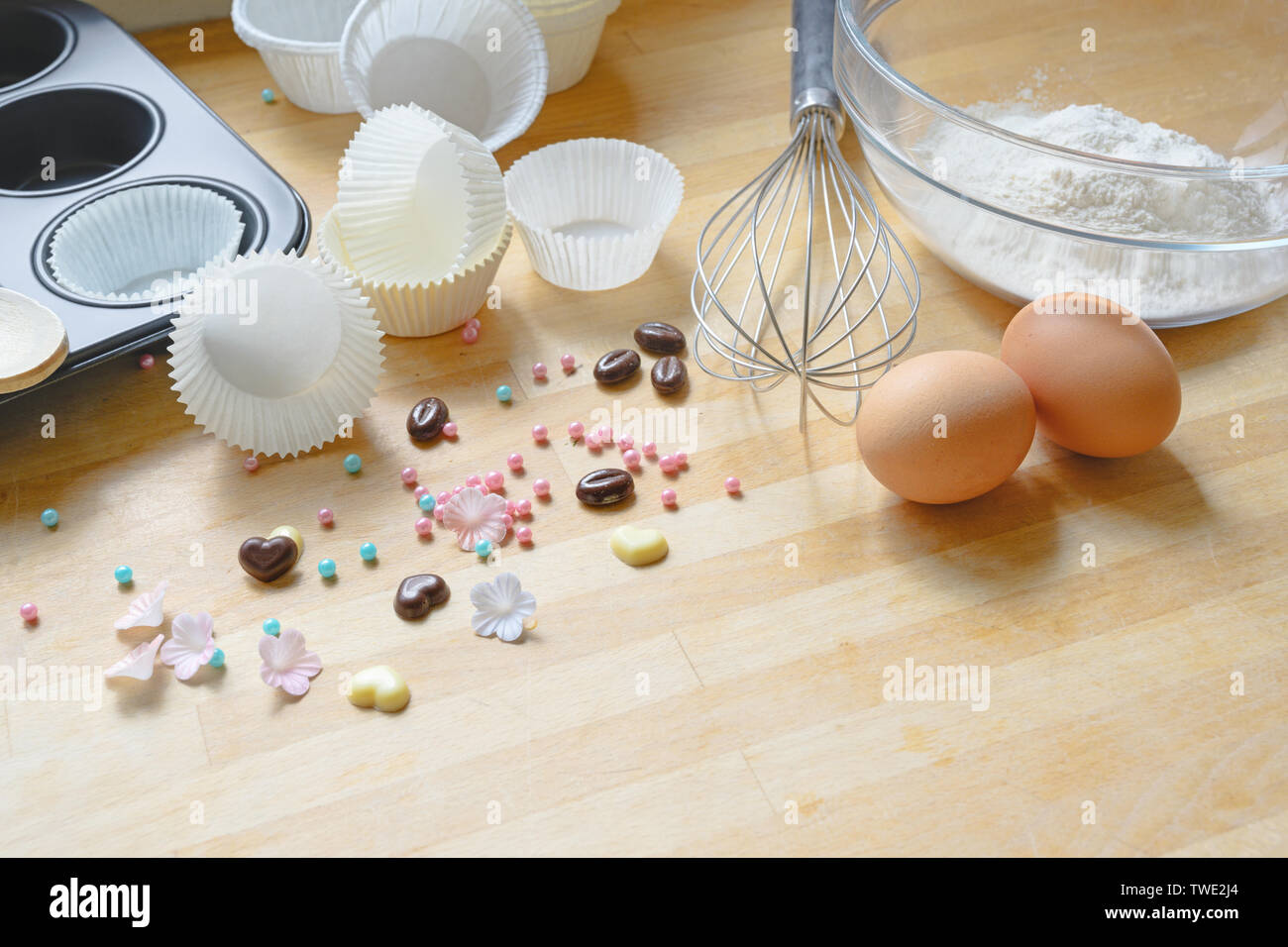 making cupcakes, tools and ingredients on a wooden kitchen board, copy space, selected focus Stock Photo