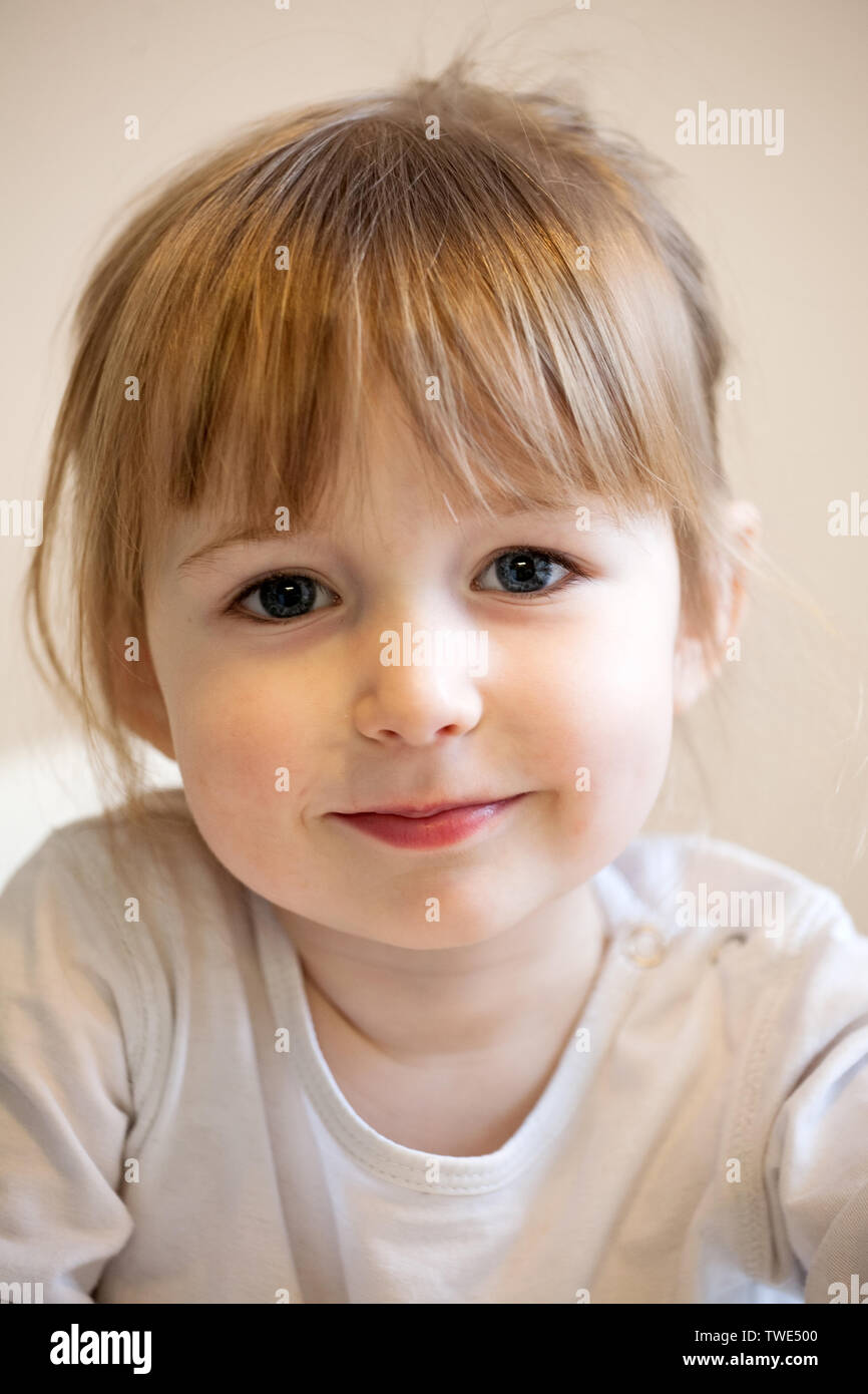 Cute Smiling Child Girl With Blonde Hair And Quiff Closeup