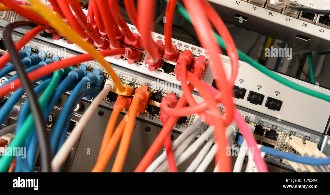 network server panel with colorful ethernet cable on switches in a school system Stock Photo