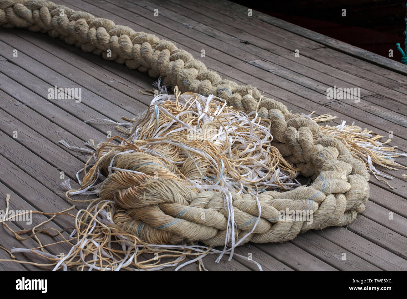 thick ship's rope laying on wooden deck of vessel Stock Photo - Alamy